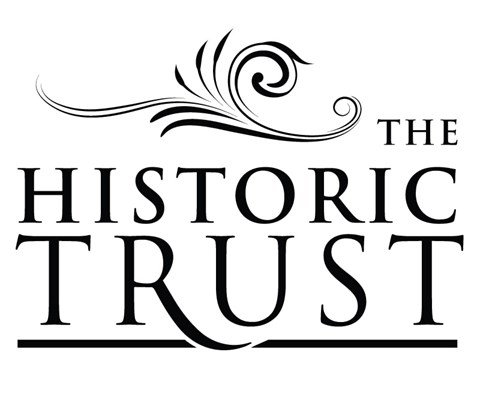 The image shows a logo with the words "The Historic Trust" in a stylized font, with a decorative swirl above the text.