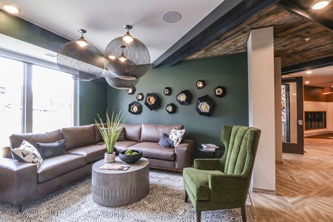 a living room with green walls and a brown couch
