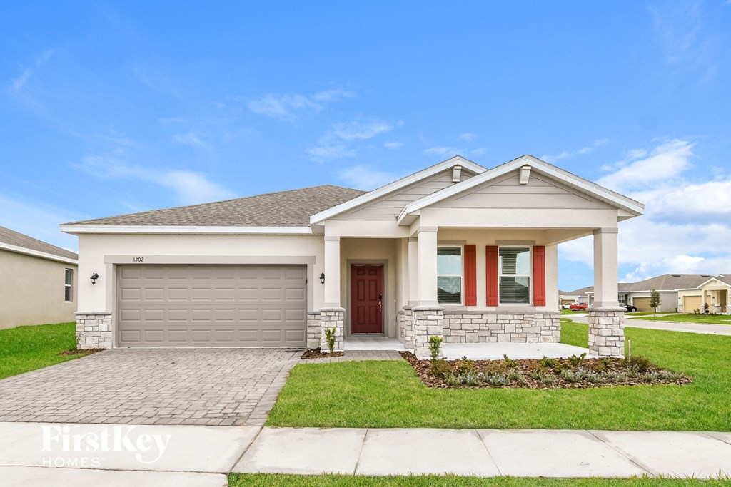 a white house with a driveway and a garage door