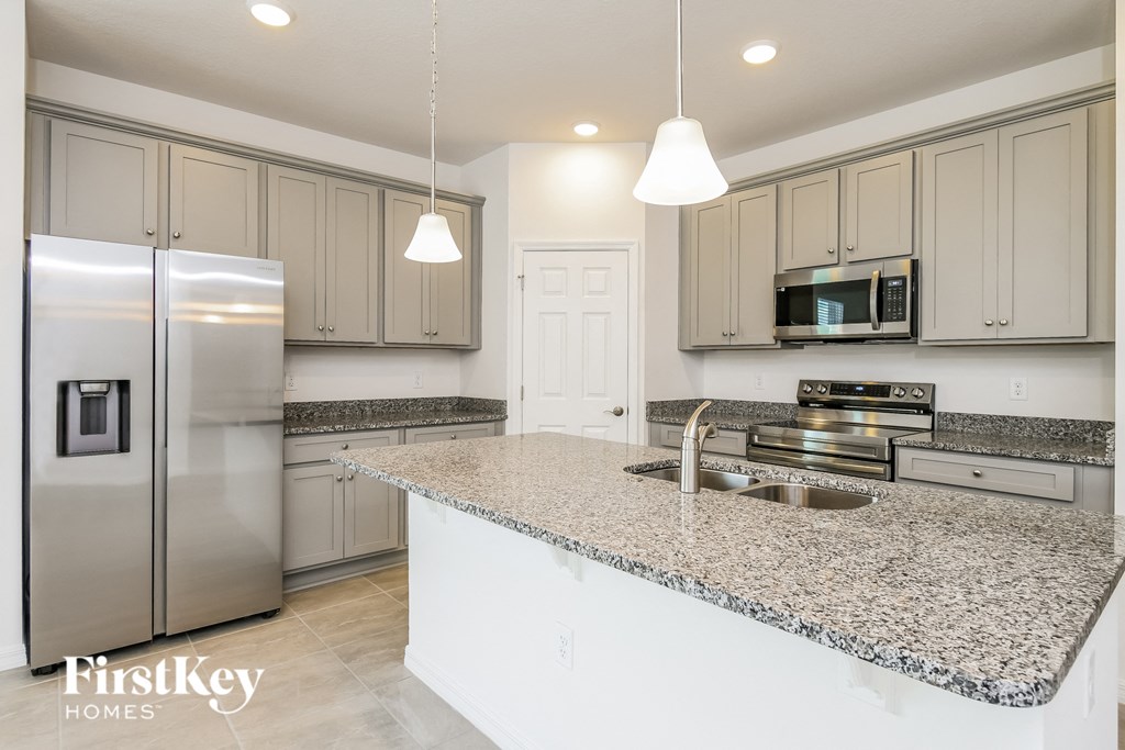 a kitchen with granite counter tops and stainless steel appliances