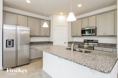 a kitchen with granite counter tops and stainless steel appliances