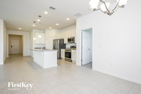 a large kitchen with white cabinets and stainless steel appliances
