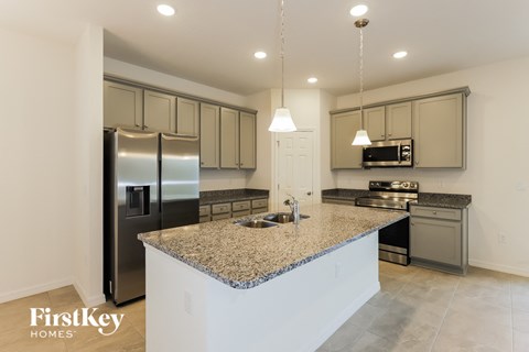 a kitchen with granite counter tops and stainless steel appliances