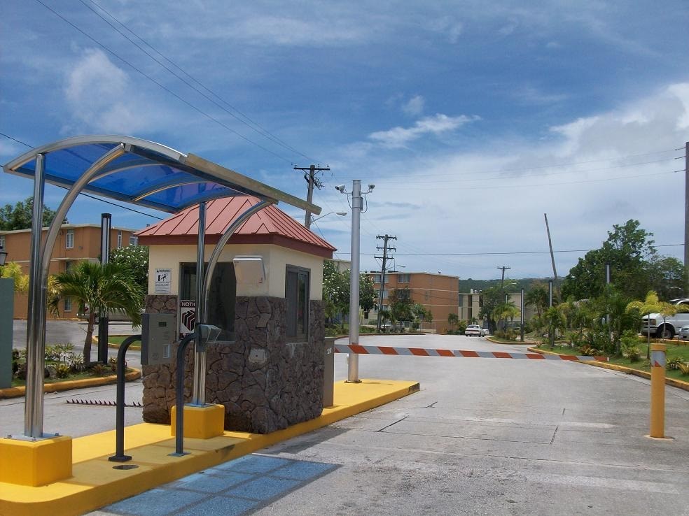 a toll booth at a gas station in a parking lot