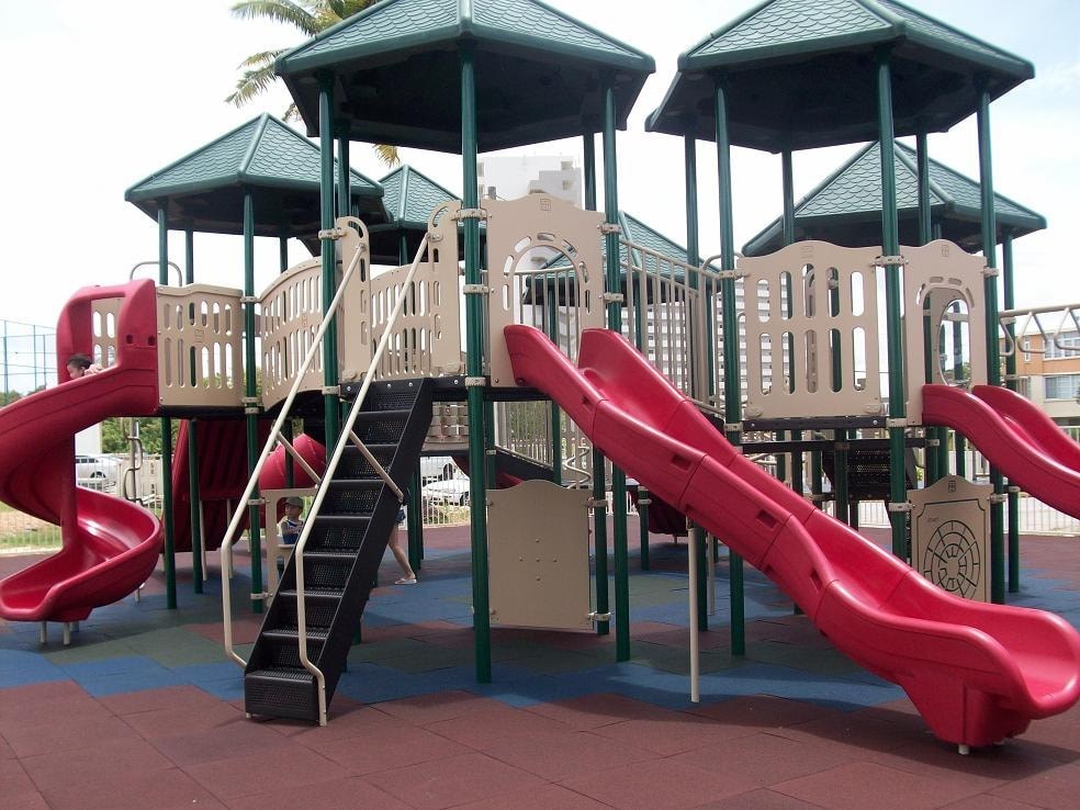 a playground with a bunch of slides and stairs