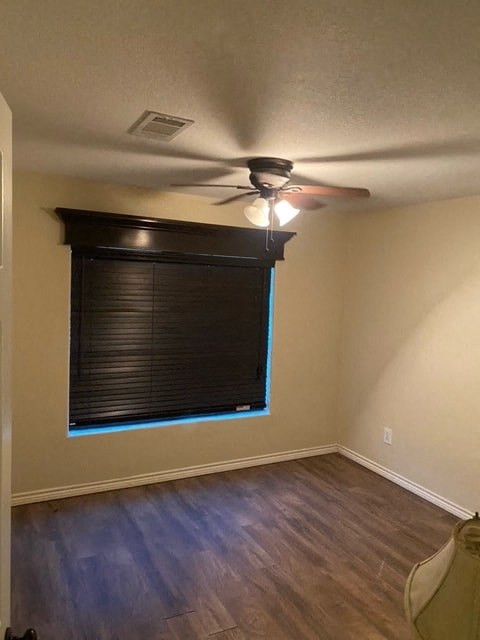 a living room with a window and a ceiling fan