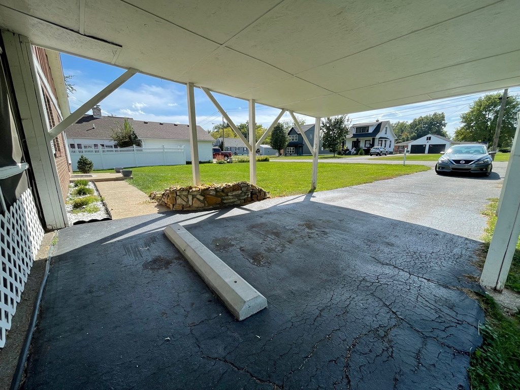 a car parked in a driveway under a covered porch