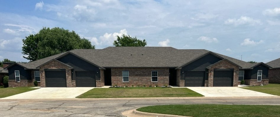 a brown brick house with a gray roof