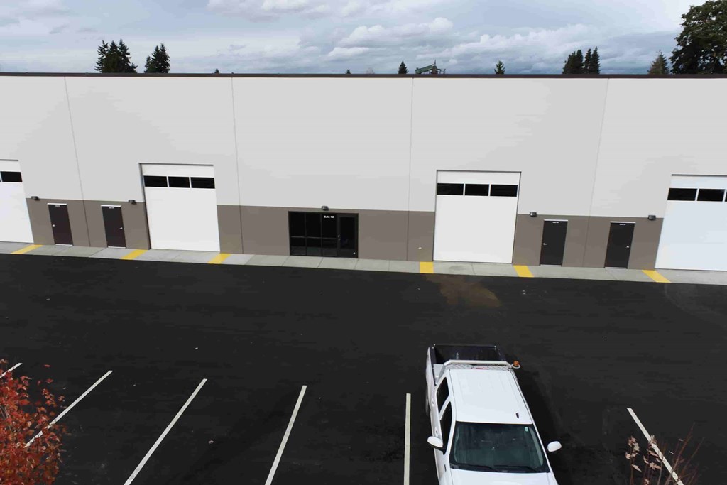 a white truck parked in front of a white building
