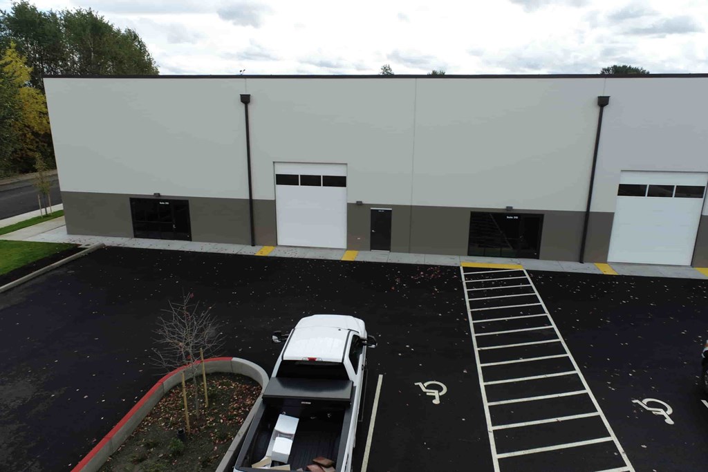 a white car parked in front of a building
