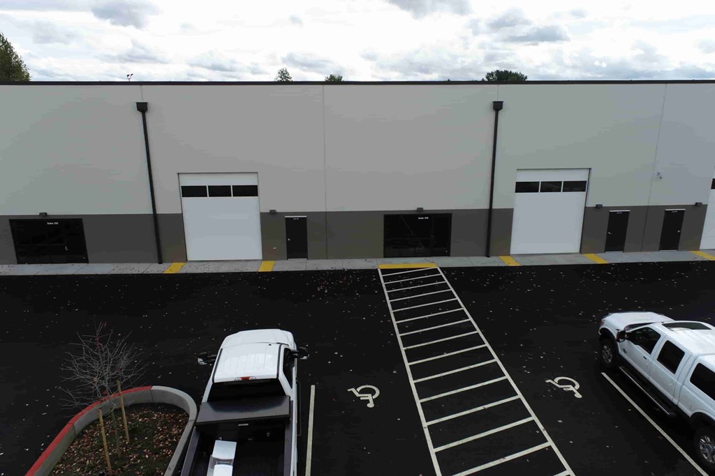 a parking lot with cars in front of a building