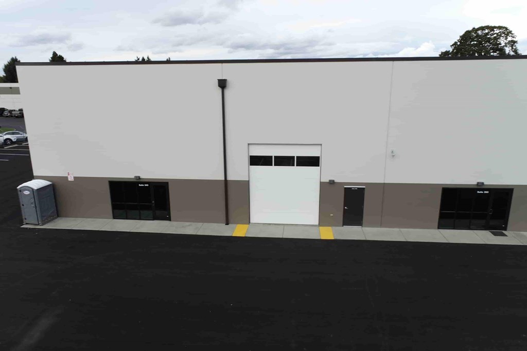 a white and brown building with a white door