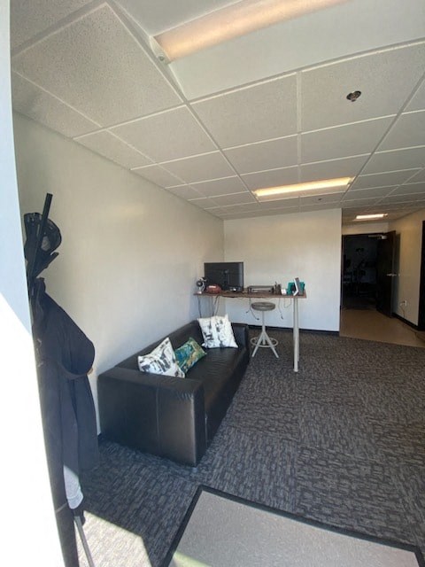 a living room with a couch and a desk