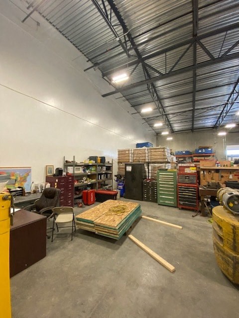 a room with a bunch of boxes and furniture in it