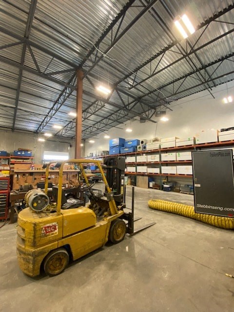 a forklift is parked inside of a warehouse