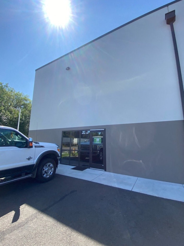a white truck parked in front of a building with a door