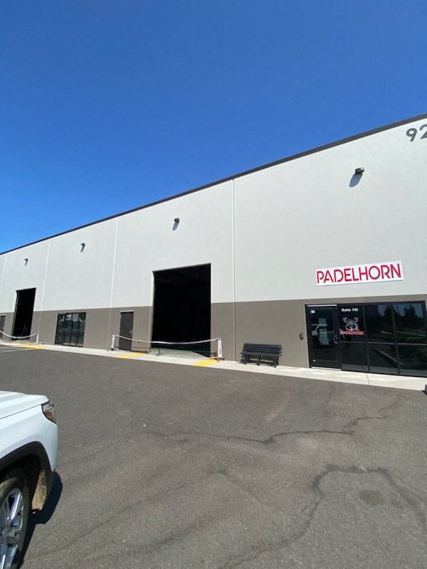 a white building with a parking lot in front of it