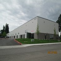 a large white building on the side of a street