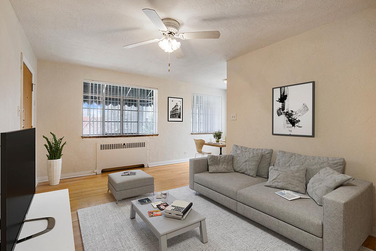 a living room with a couch and a ceiling fan