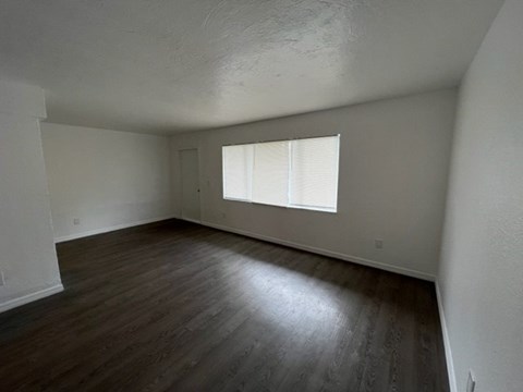 A room with wooden floors and a window.