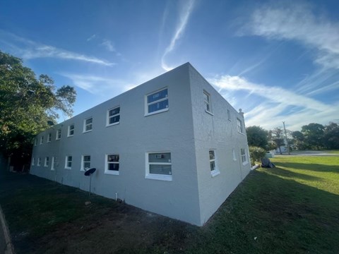 A white building with a blue sky in the background.