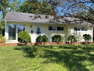 a white house with a lawn in front of it