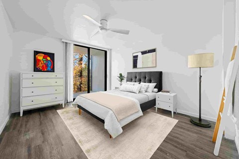 a white bedroom with a bed and a ceiling fan