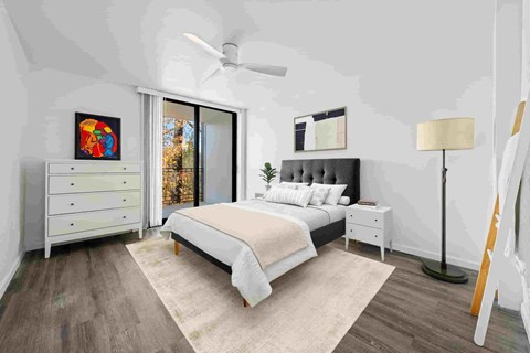 a white bedroom with a bed and a ceiling fan