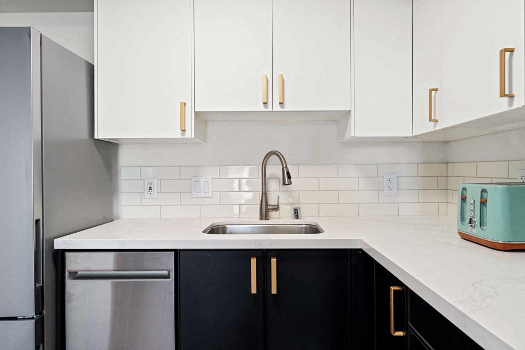 a kitchen with white cabinets and a sink