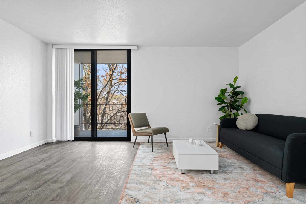 a living room with a couch and a table and a sliding glass door