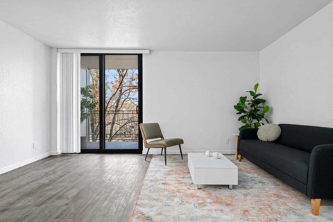 a living room with a couch and a table and a sliding glass door