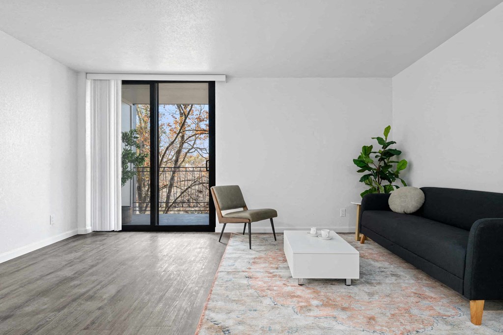 a living room with a couch and a table and a sliding glass door