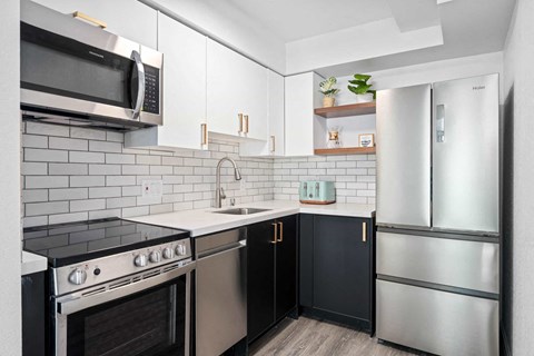 a kitchen with stainless steel appliances and white cabinets