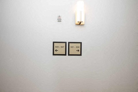 a white wall with two switches and a candle