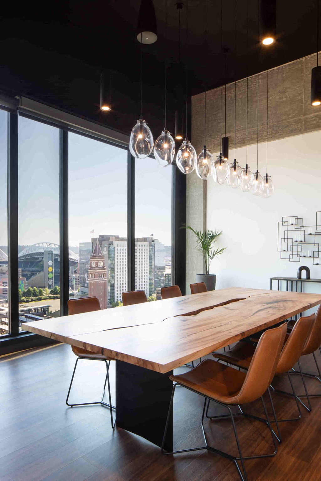 a dining room with a wooden table and a city view