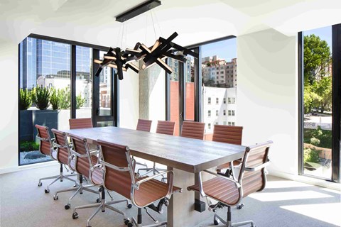 a dining room with a long table and chairs and a chandelier