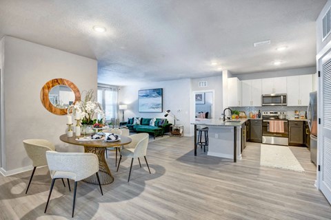 A modern kitchen with a dining table set for four.
