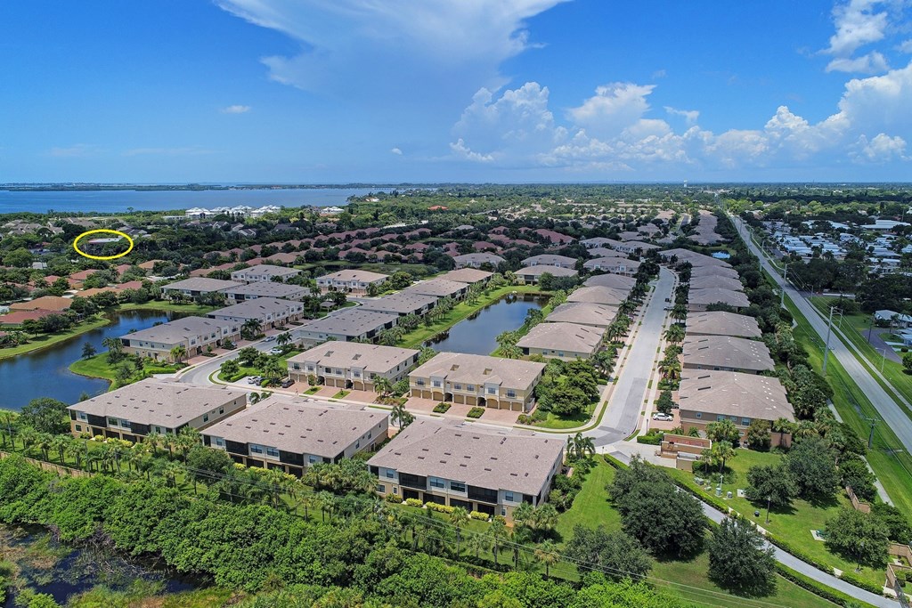 an aerial view of a neighborhood with a yellow circle around a building in the middle