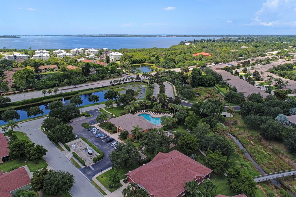 an aerial view of the resort with a lake in the background