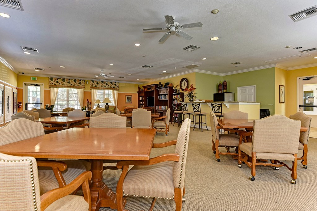 a dining room with tables and chairs and a ceiling fan