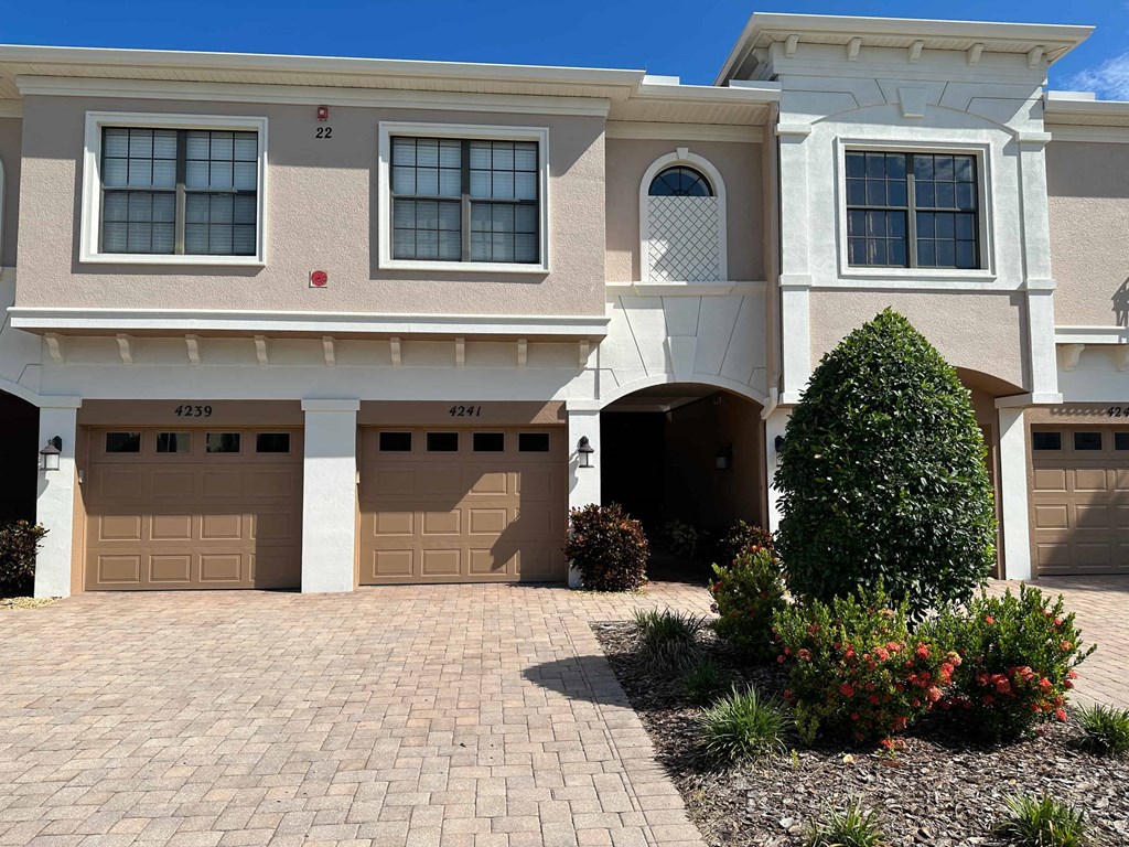 a house with two garage doors and a driveway