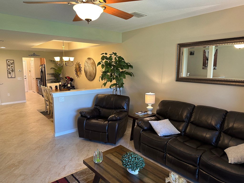 a living room with leather couches and a table