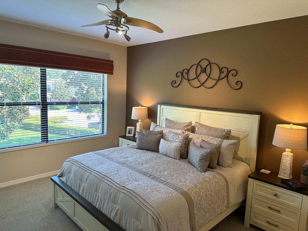 a bedroom with a bed and a ceiling fan