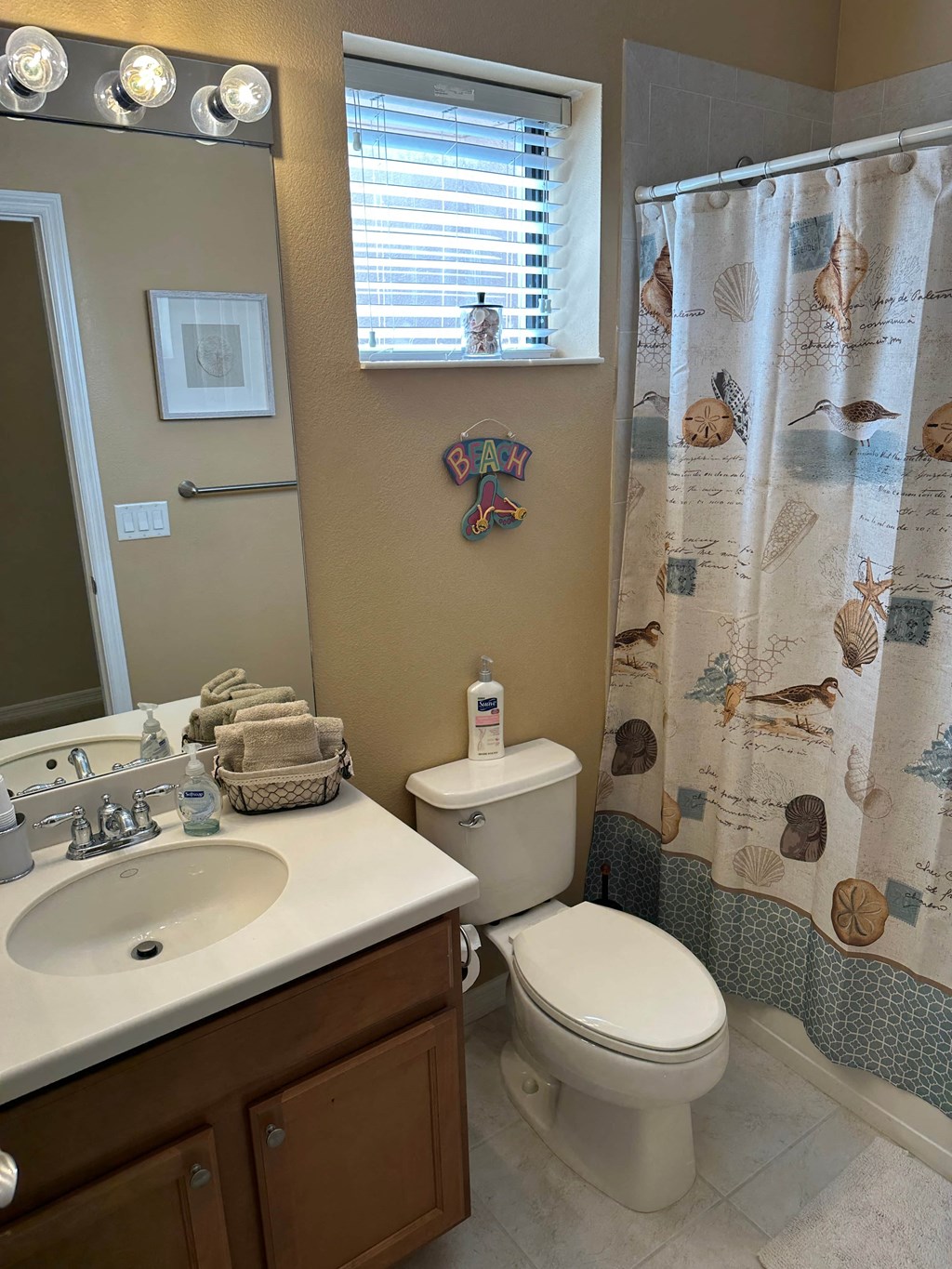 a bathroom with a toilet and a sink and a shower curtain