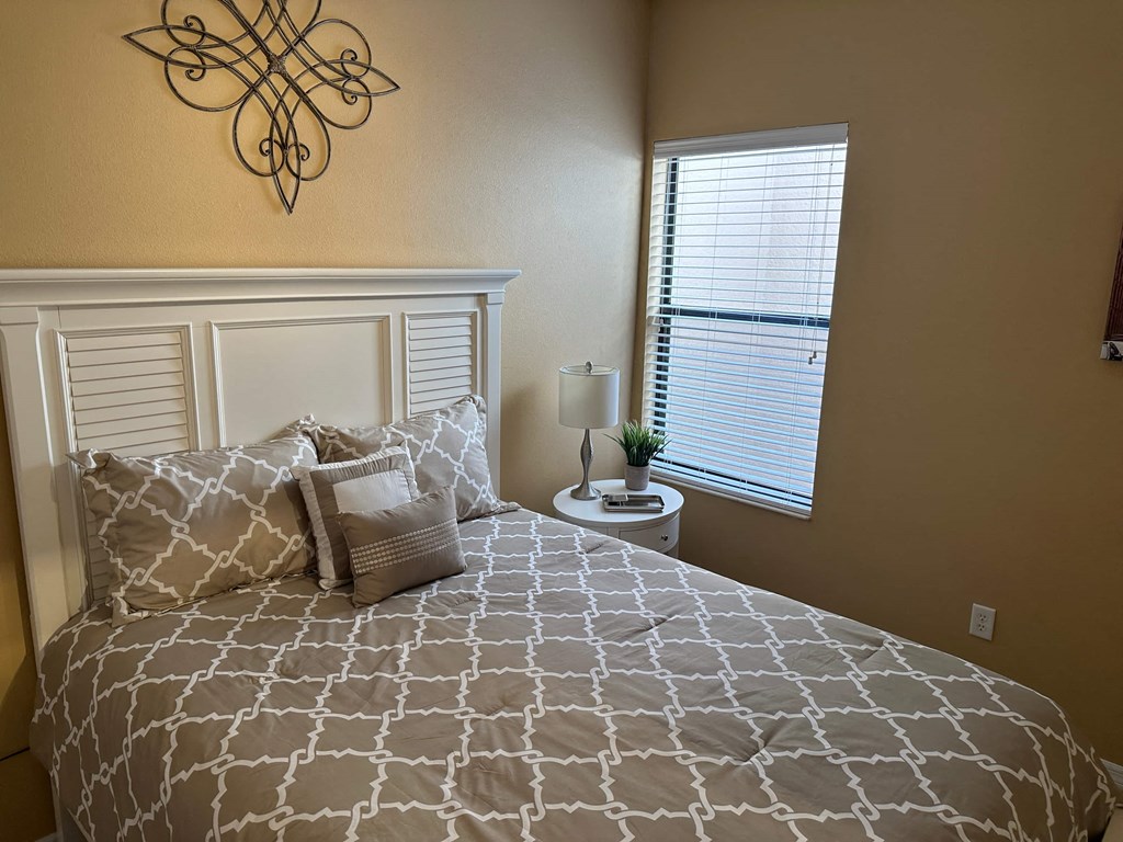 a bedroom with a bed and a window