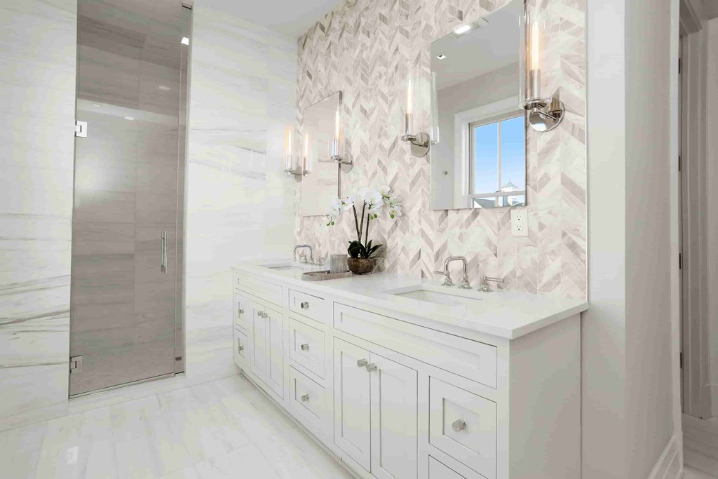 A bathroom with a white vanity and a mirror above it.