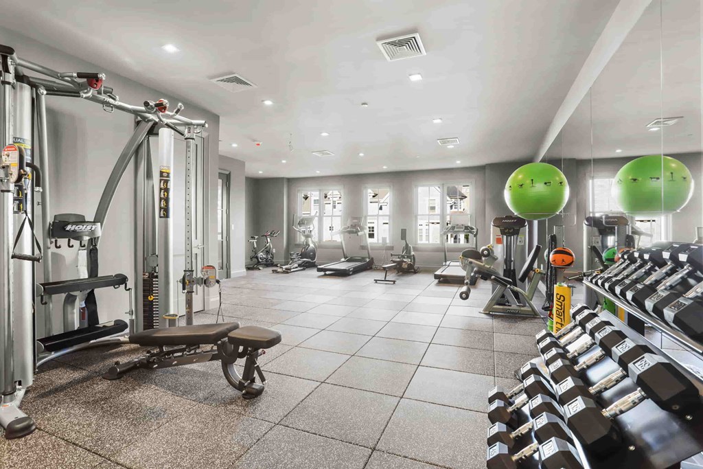 A gym with a variety of equipment including a leg press machine.