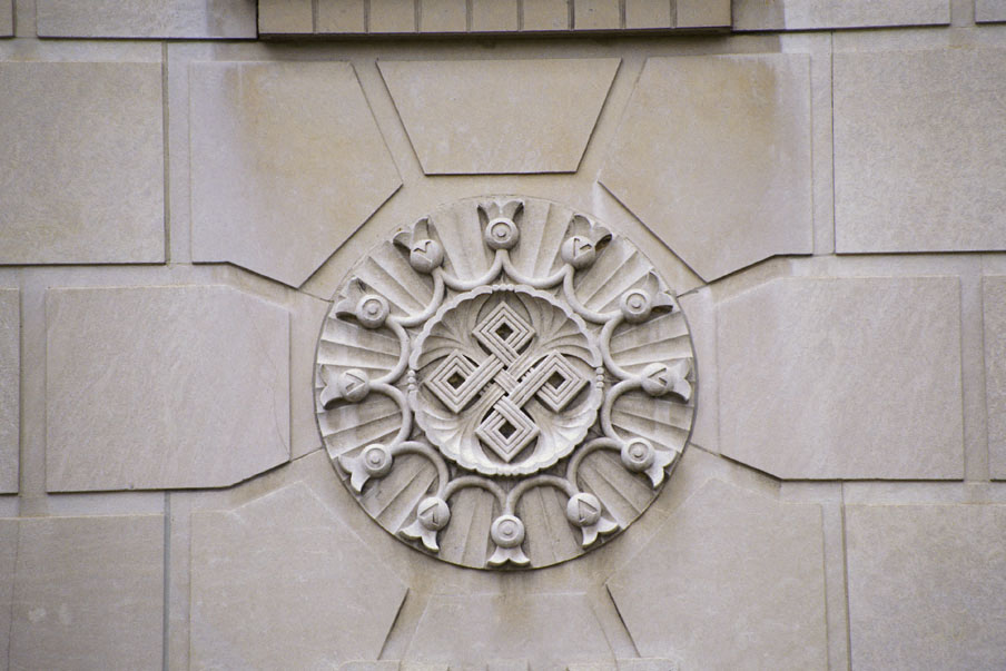 a stone wall with a circular design on it