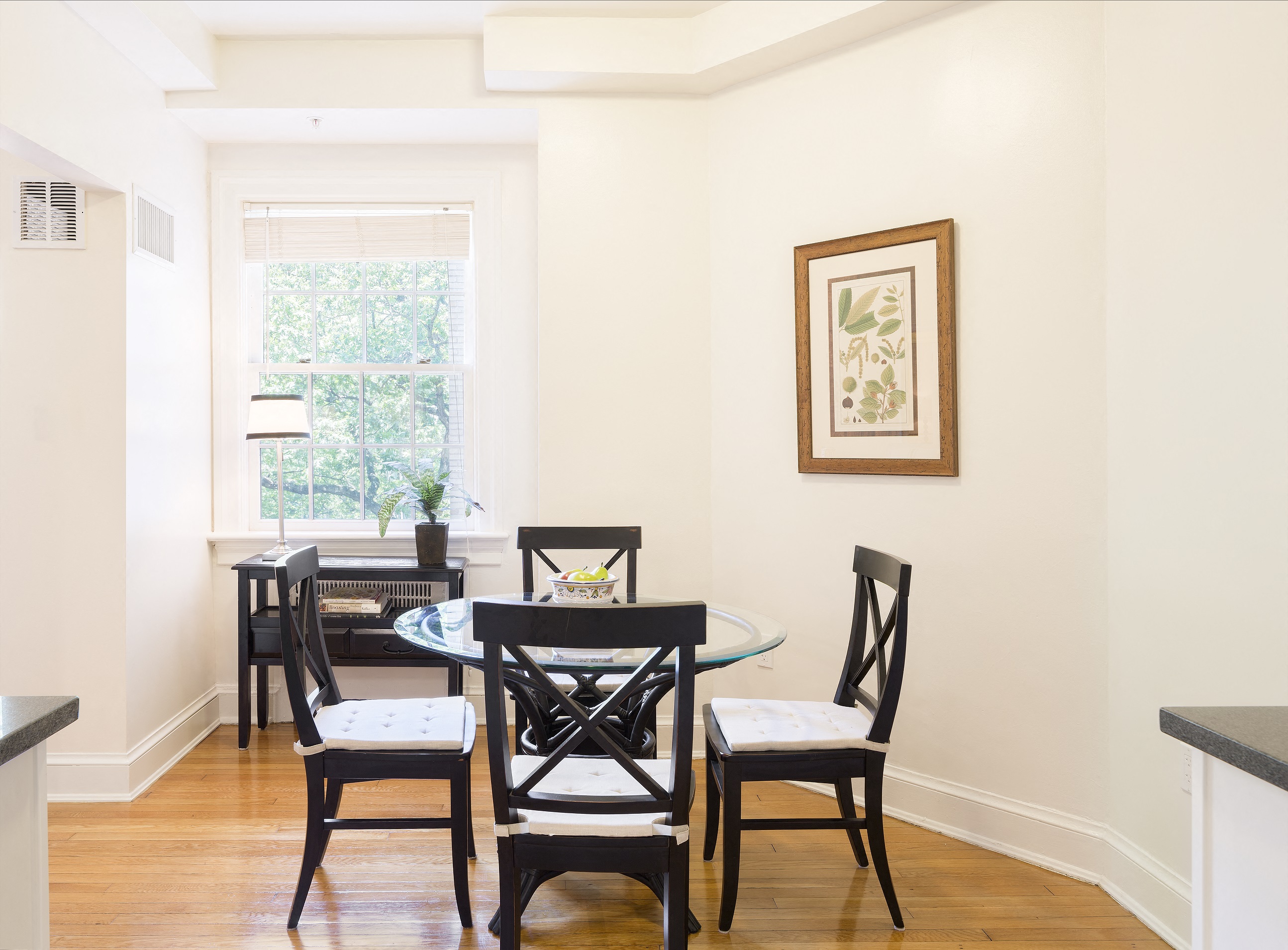 a dining room with a table and chairs and a window