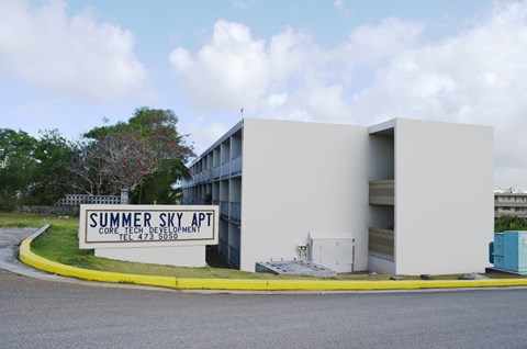 a white building with a sign in front of it